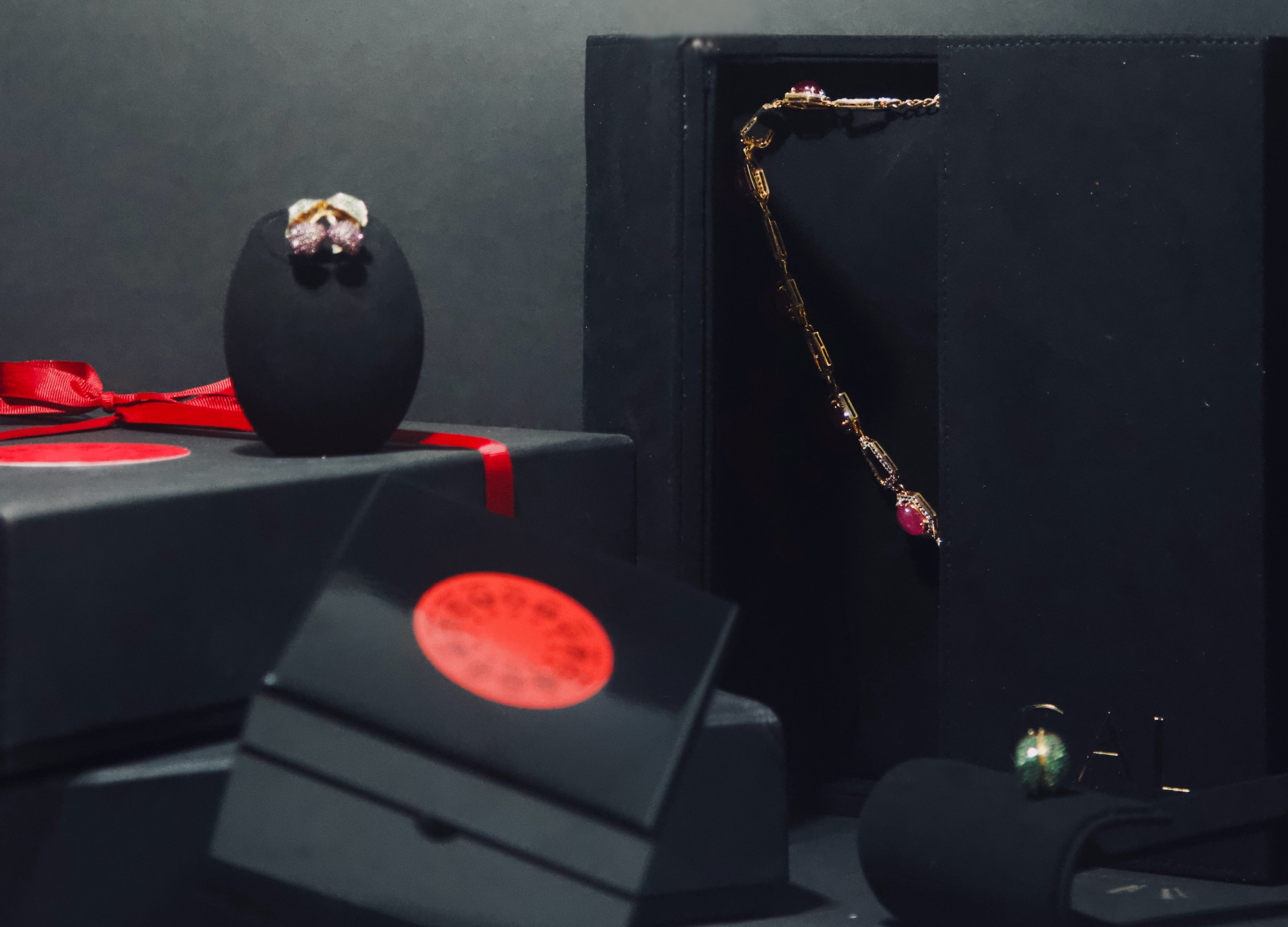 Black jewelry box with red accents on a dark surface